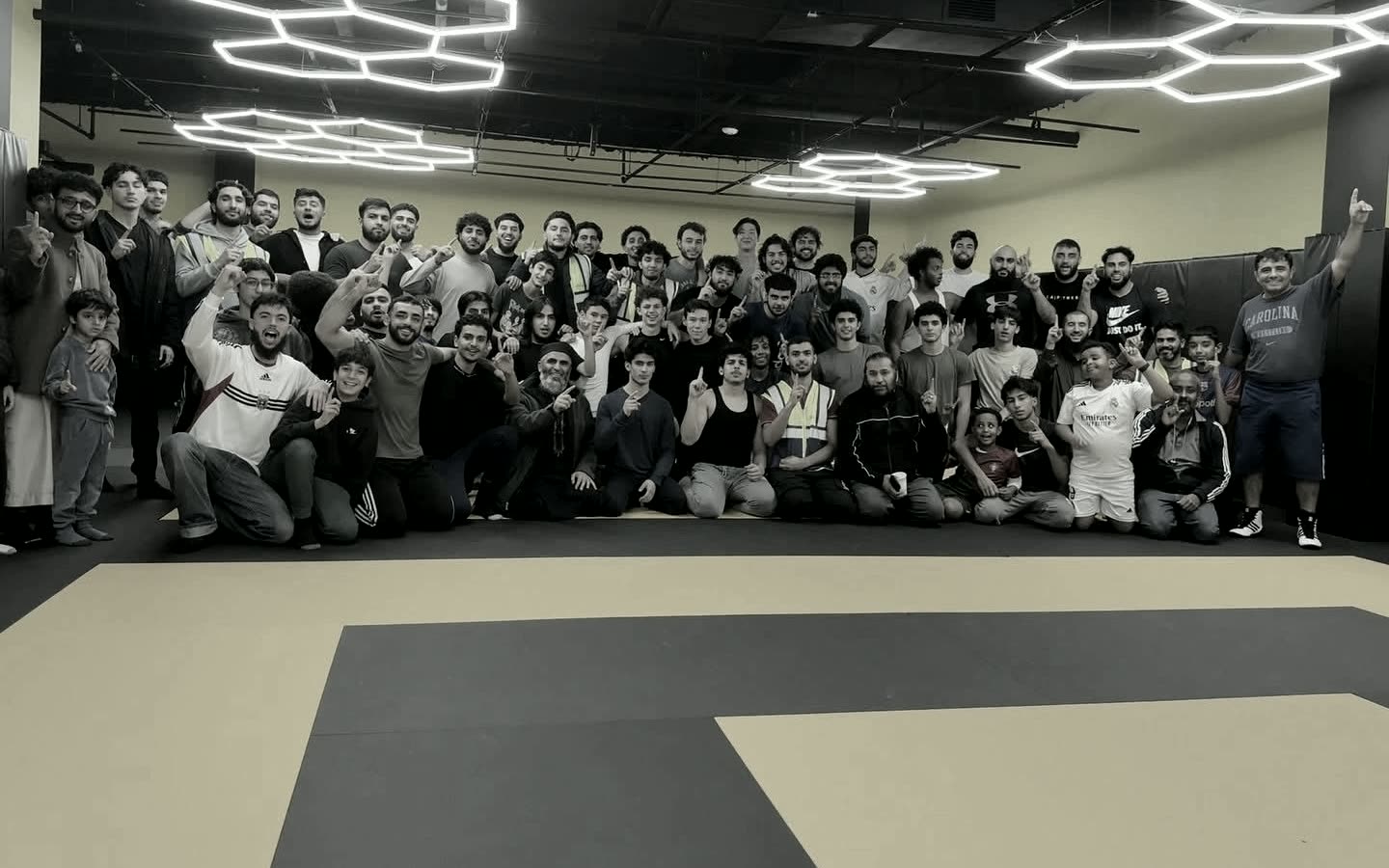 Hive members of all ages gathered on the mat for a group photo
